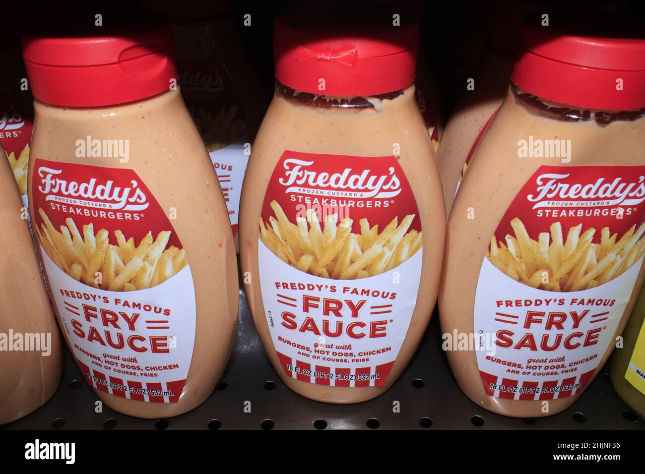 A closeup of Freddy's FRY SAUCE on a metal shelf in a Dillons store