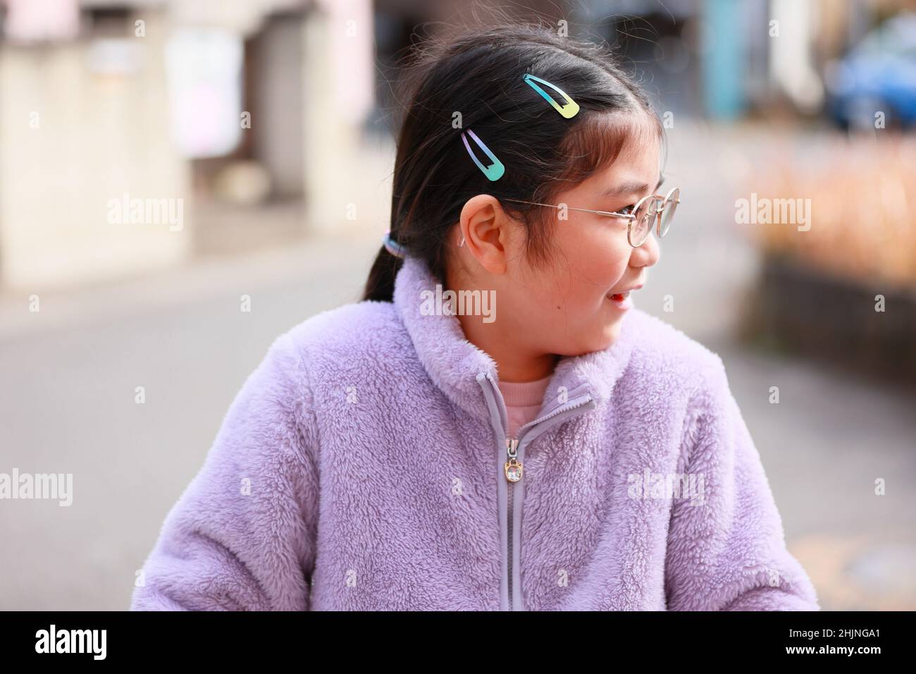 Child Profile View in Close Up  while riding on a Bicycle. Bicycle not shown on Photo Stock Photo