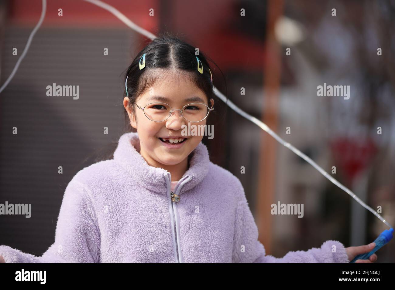 Child Happily Exercise with Jumping Rope Stock Photo