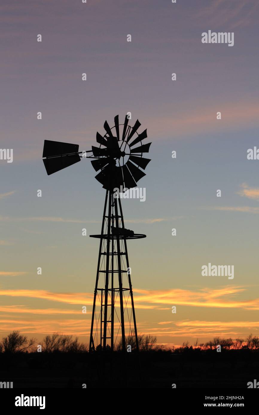 Kansas Windmill at sunset with clouds Stock Photo