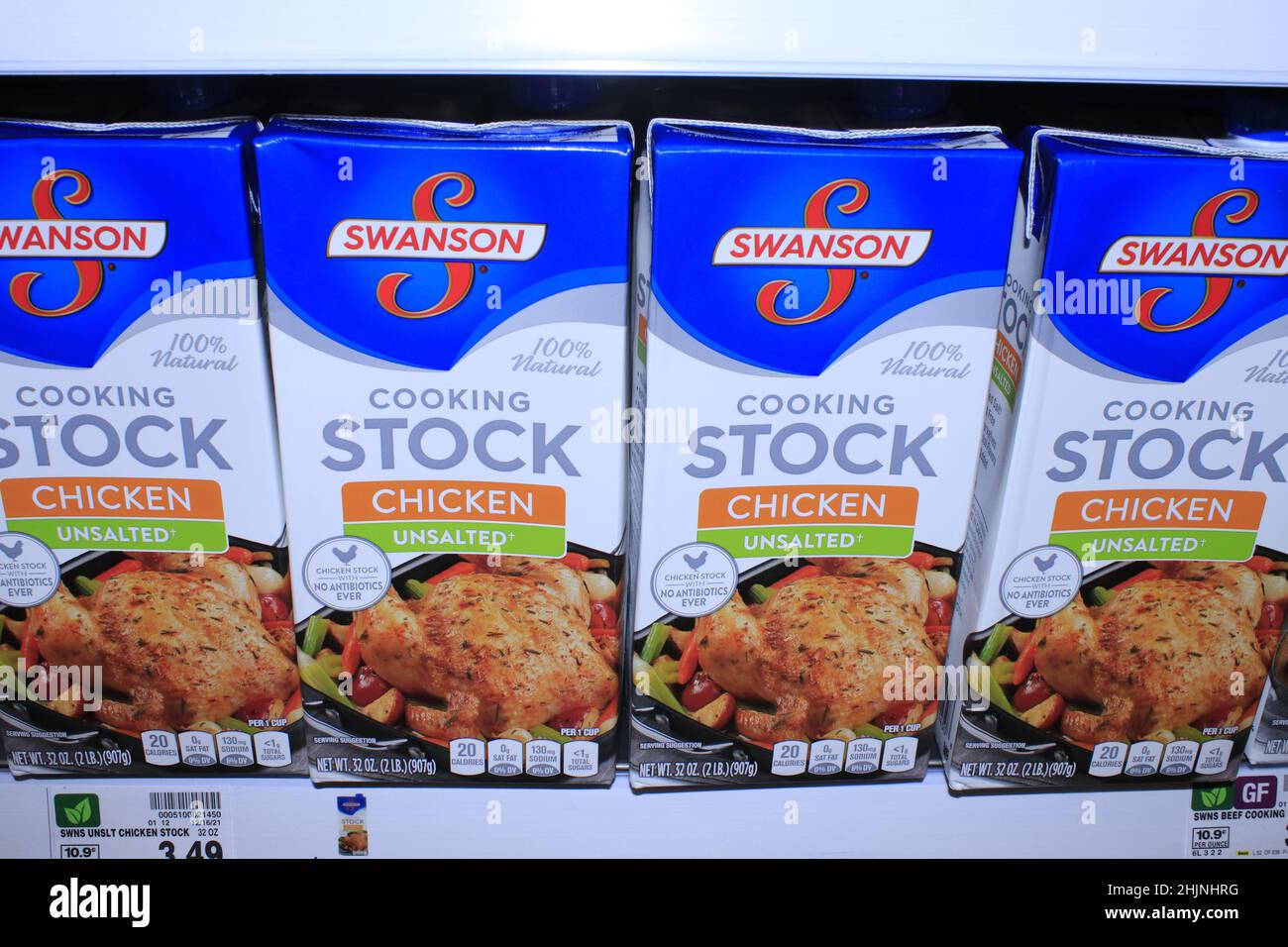 Swanson Cooking Stock Chicken Broth in boxes shot closeup on a metal shelf in a grocery store in