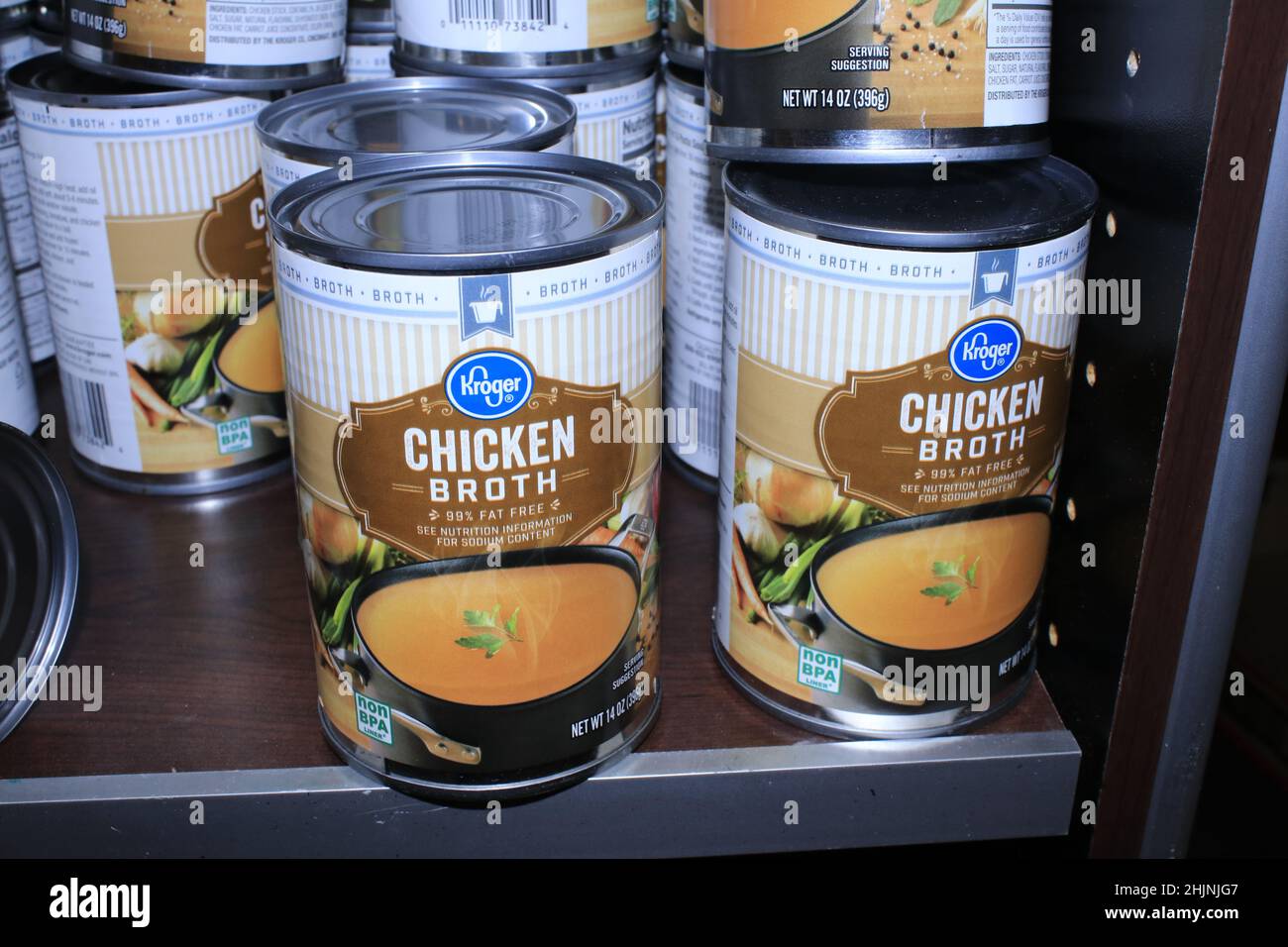 A closeup of Kroger Chicken Broth in cans on a metal shelf at a Dillons store in Kansas Stock Photo