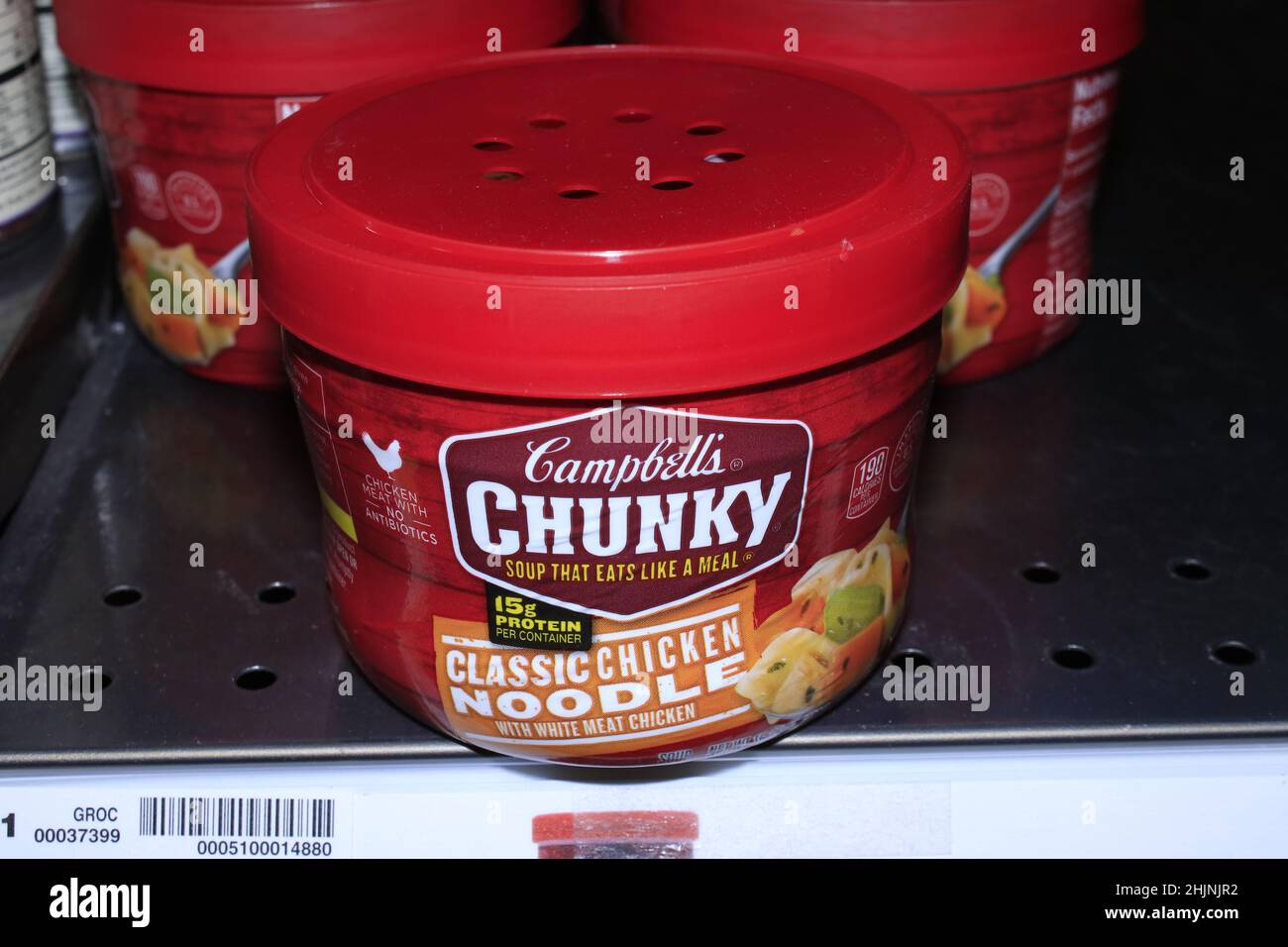A closeup of CAMPBELL'S  CHUNKY Chicken Noodle soup on a metal shelf in a Dillons grocery store in Kansas Stock Photo