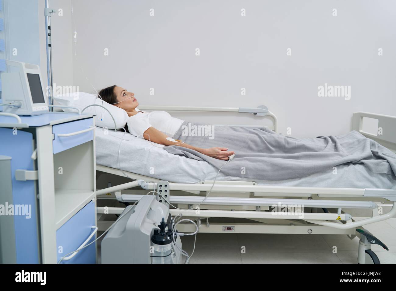 Caucasian female patient connected to oxygen concentrator Stock Photo