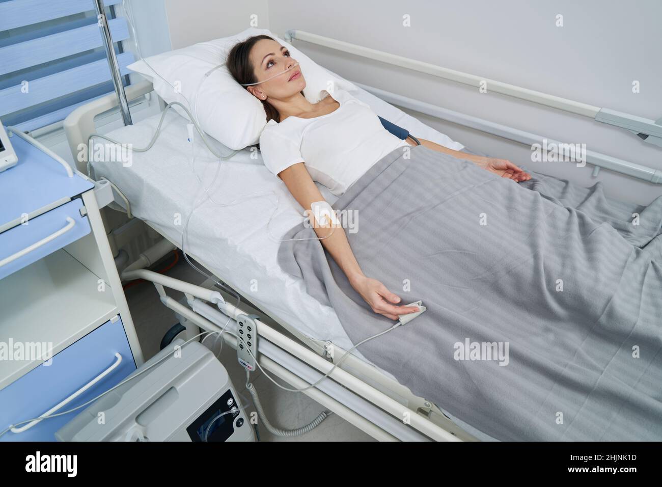 Patient connected to oxygen concentrator during intravenous therapy Stock Photo