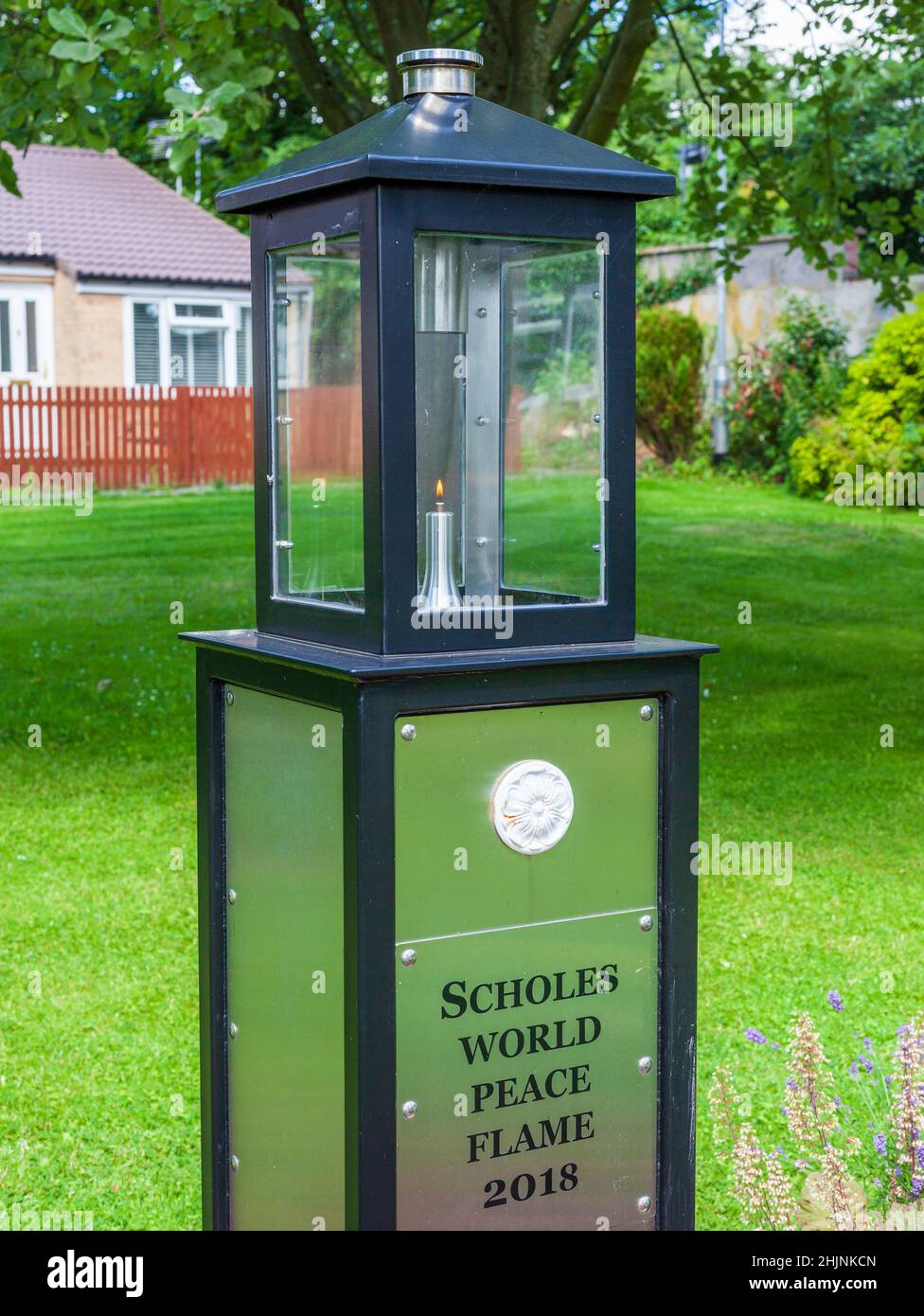 The World peace Flame in a garden in Scholes, Leeds, West Yorkshire Stock Photo