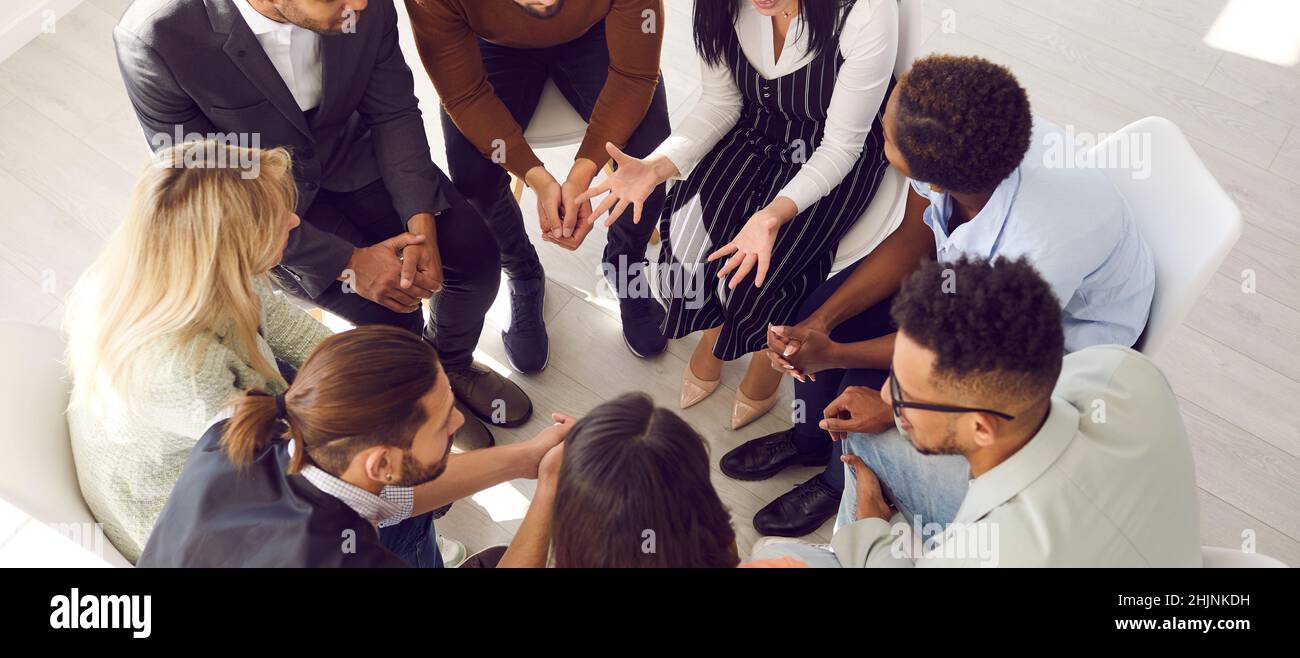 People sitting in circle share problems during psychological rehabilitation session. Stock Photo