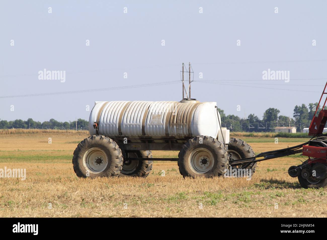 A Case International farm tractor in a farm field with spray equipment