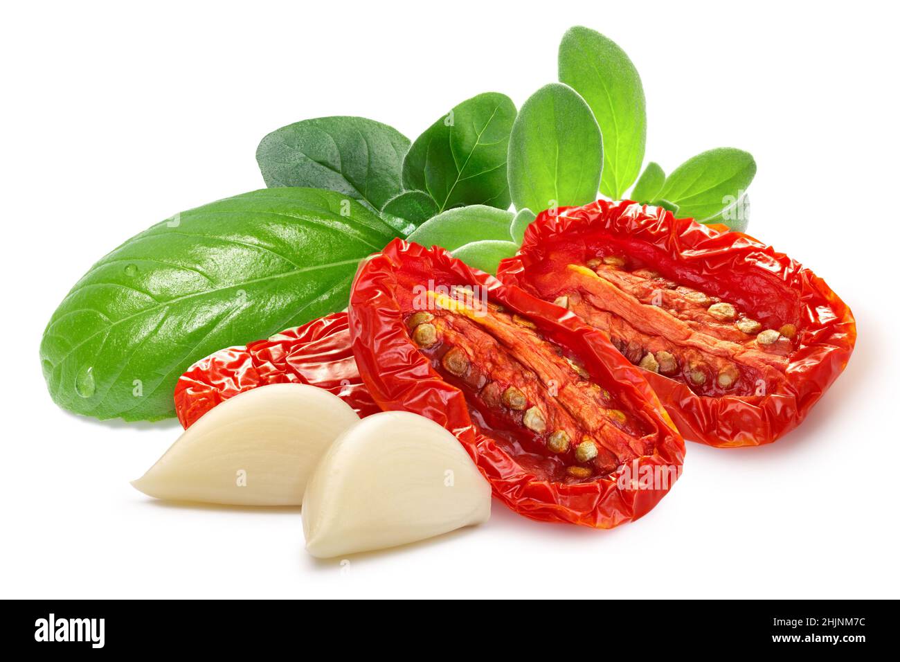 Dried or Sundried tomato halves with herbs and garlic isolated Stock Photo