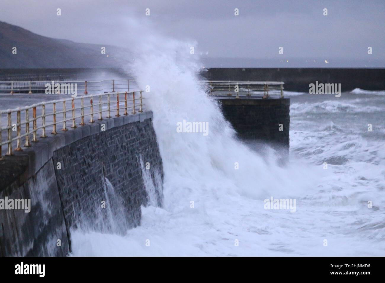 Aberystwyth Wales UK weather 31st January 2022 . In the aftermath of storm CORRIE strong gale force winds gusting over 50 mph blast the west coast of Britain causing big waves which crash over the promenade and harbour walls in Aberystwyth, with damage to structure and property possible . Credit: mike davies/Alamy Live News Stock Photo