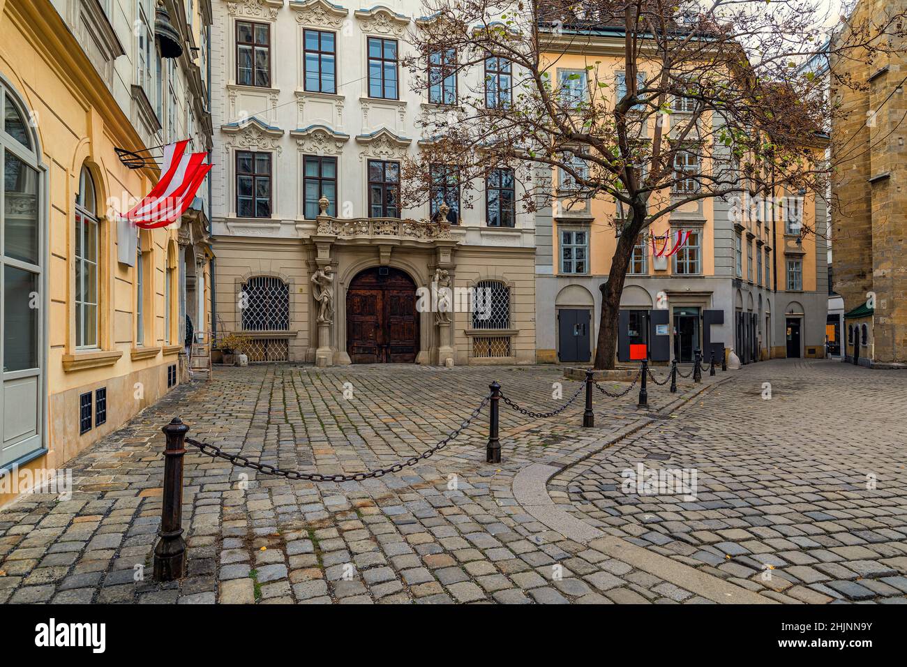 Old cobblestone street and pedestrian walkway among historic buildings in the center of Vienna, Austria. Stock Photo