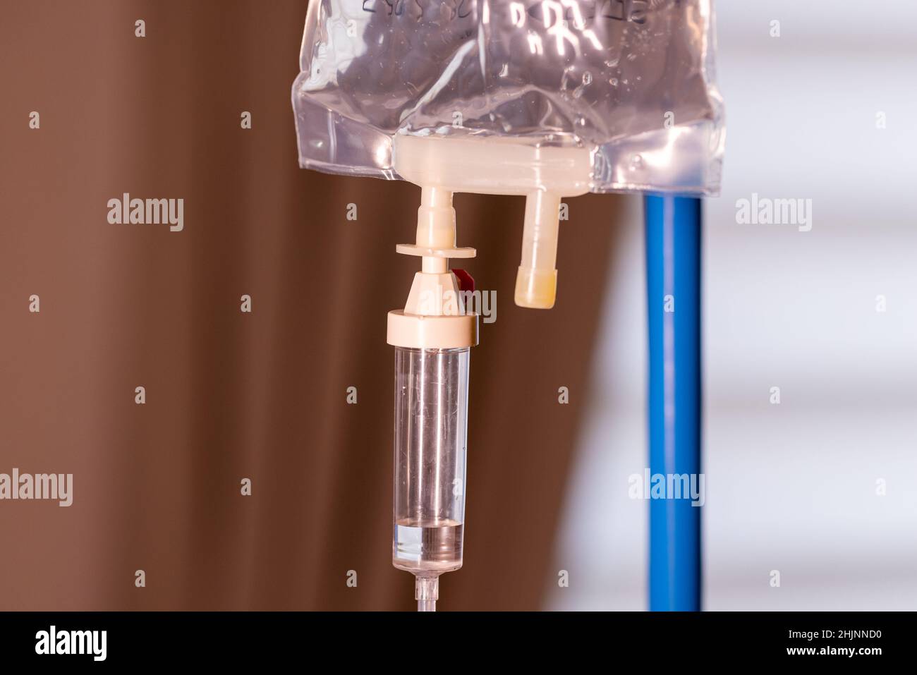 saline water or medicine or chemotherapy drops machine or medical instruments for infusion to blood vessel and for treatment sick or patient healthcare in hospital or clinic on window sunlight with space. High quality photo Stock Photo