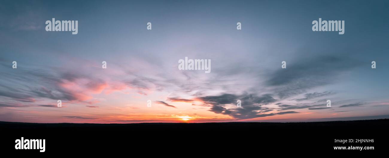 sunset panorama with raspberry clouds on a blue sky background Stock ...