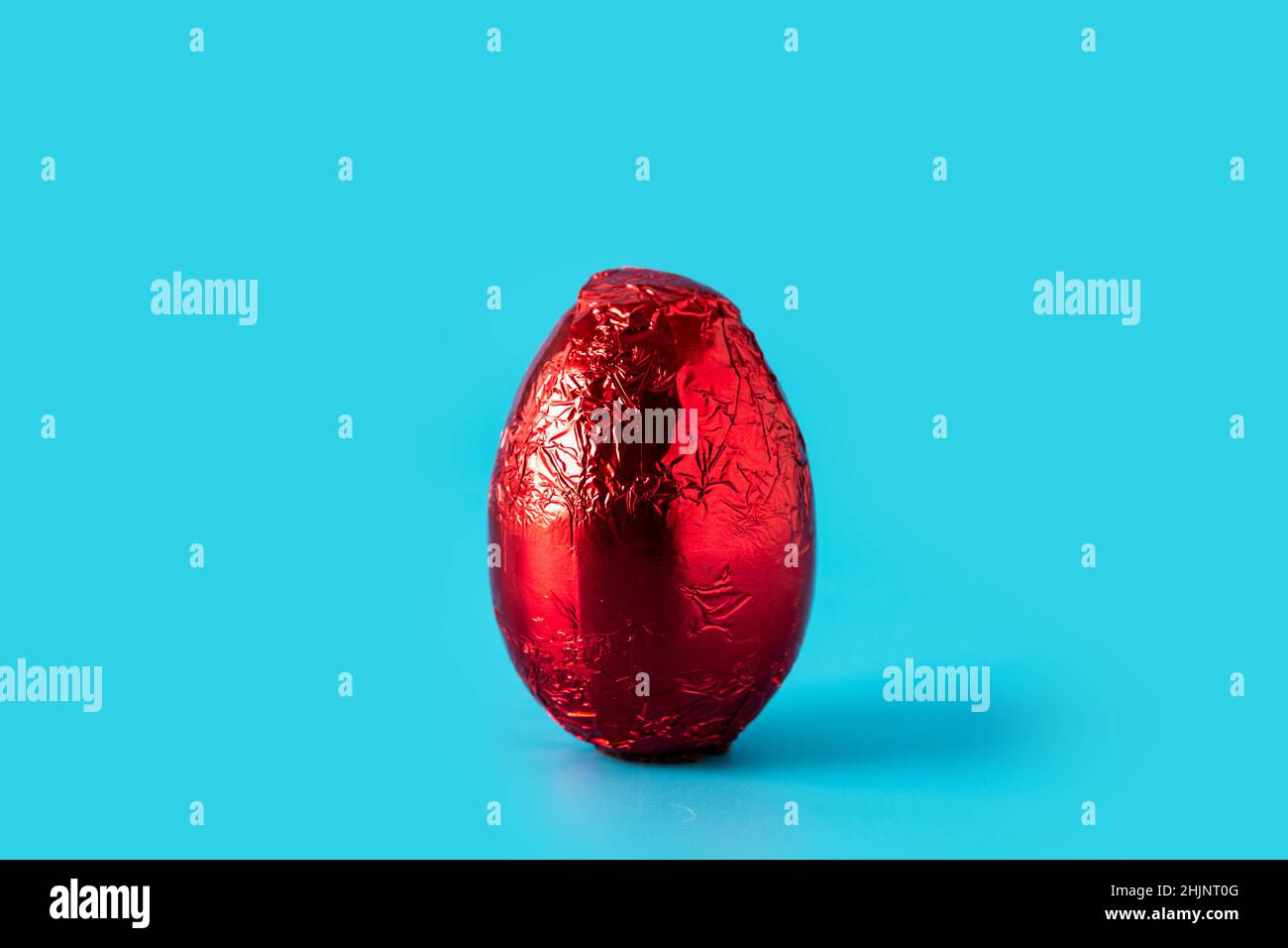 Red Easter egg on blue background Stock Photo
