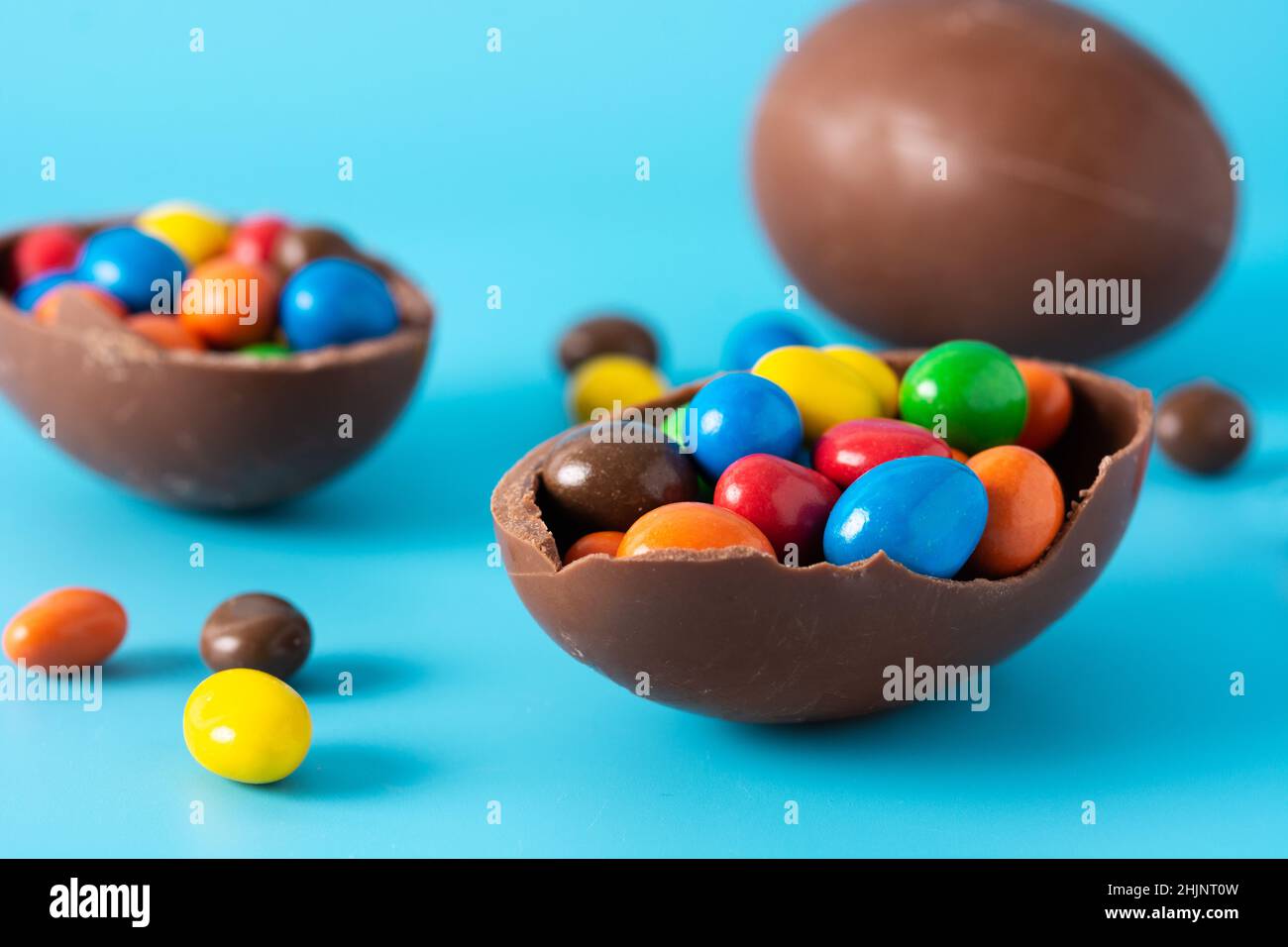 Colorful chocolate Easter eggs on blue bckground Stock Photo