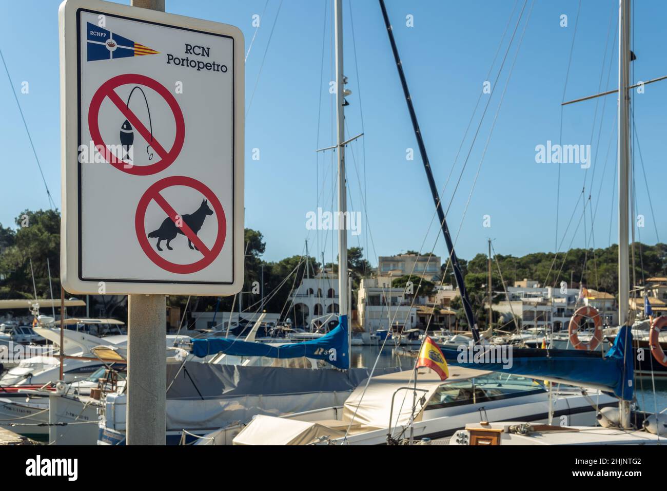 Portopetro, Spain; january 27 2022: Close-up of a sign at the Portopetro yacht club, with a sign prohibiting fishing and loose animals Stock Photo