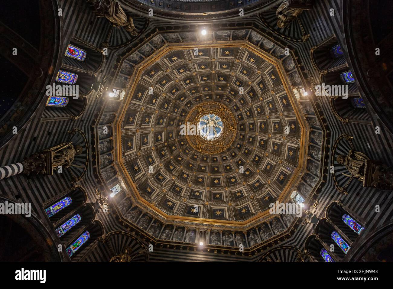 The inside of the dome of Siena Cathedral (Duomo di Siena), 1264. Gold stars in dark blue coffers, lantern,  colonnade with patriarchs and prophets. Stock Photo