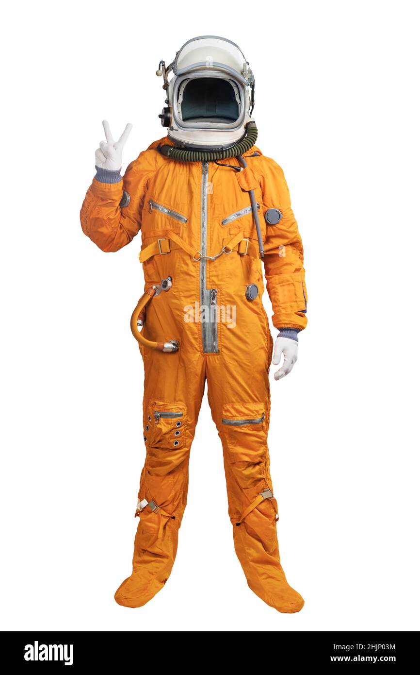 Astronaut wearing an orange spacesuit and helmet showing hand victory sign gesture isolated on white background. Unrecognizable cosmonaut with a hand Stock Photo