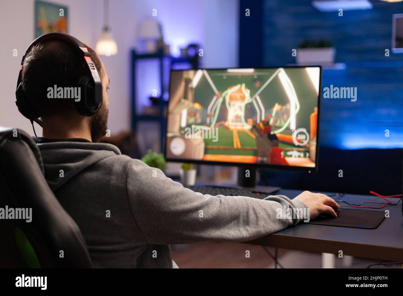 Player using keyboard and mousepad to play video games on computer. Man  wearing headphones and playing online game with mouse and gaming equipment.  Gamer doing activity for entertainment Stock Photo - Alamy