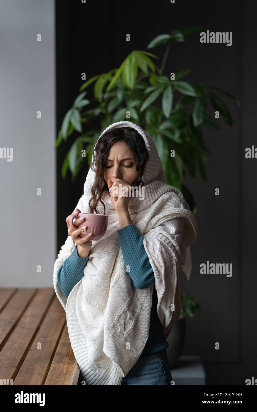 Sick woman coughing has flu, cold or coronavirus disease drink hot tea