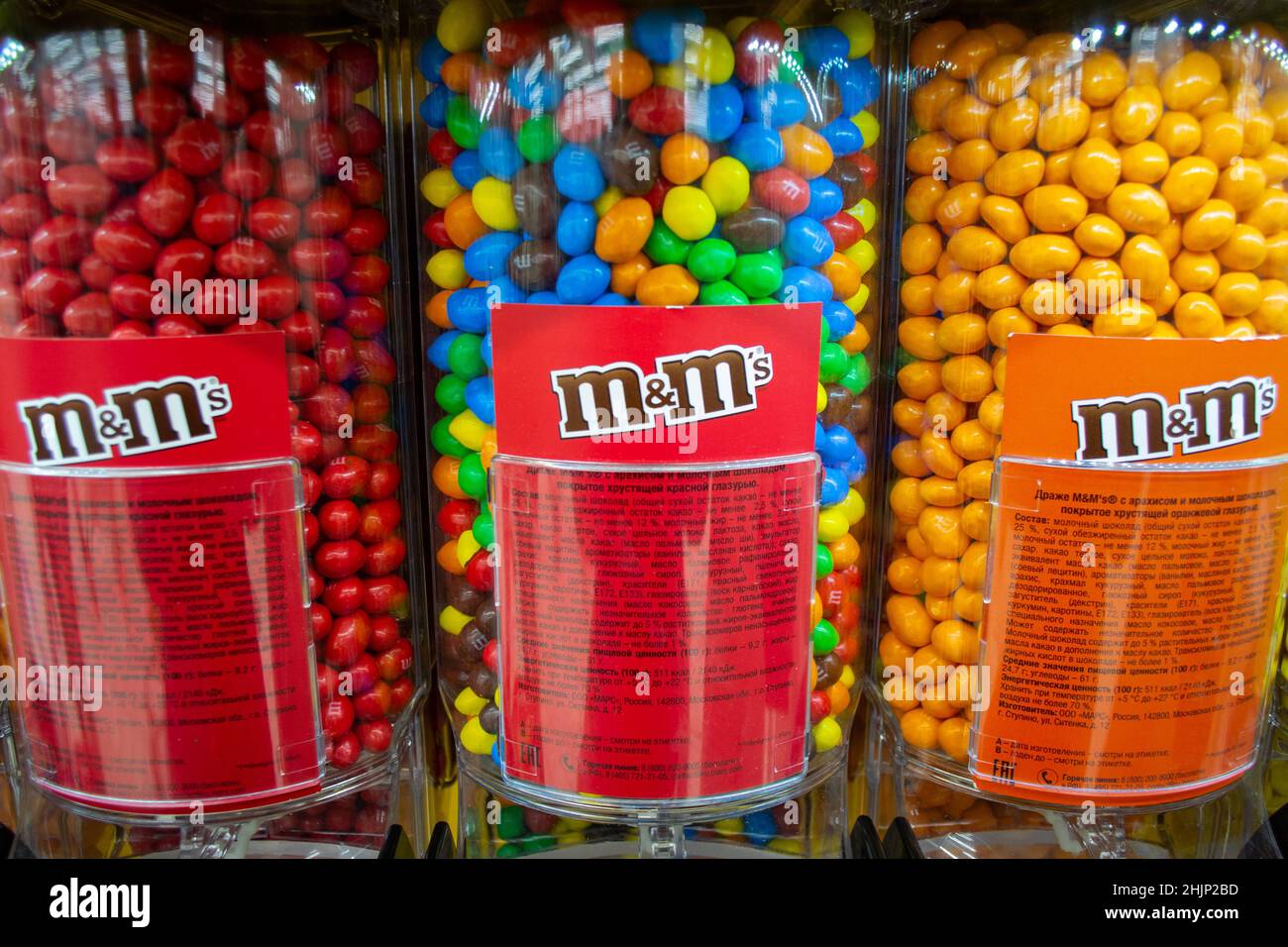 Moscow, Russia, November 2019: Close up of M M Candies at Candy Dispenser Machines in the supermarket. Colorful button-shaped chocolates in bulk. Stock Photo