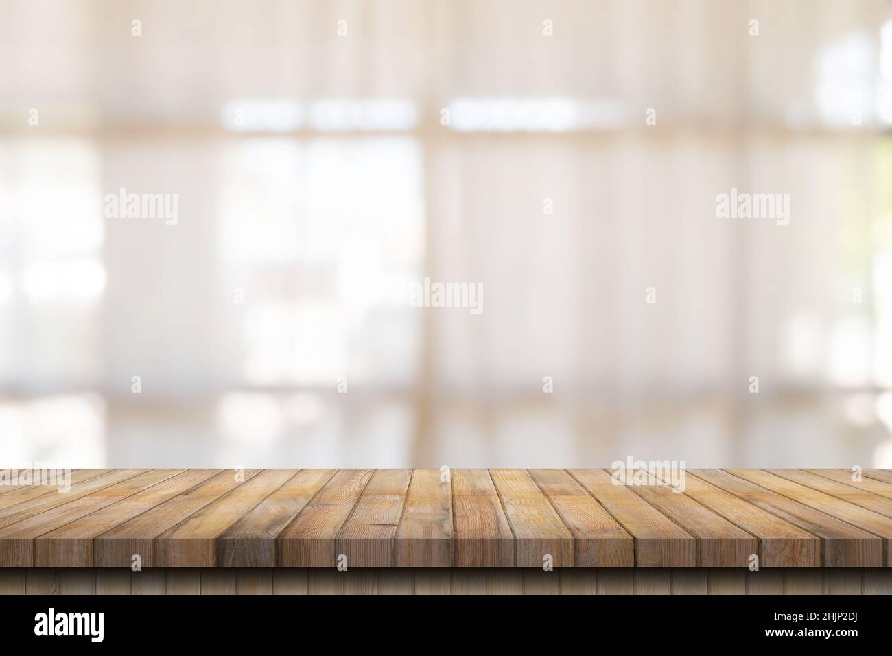Wooden table top with blurred people in coffee shop and cafe background for display montage, copy space. Stock Photo
