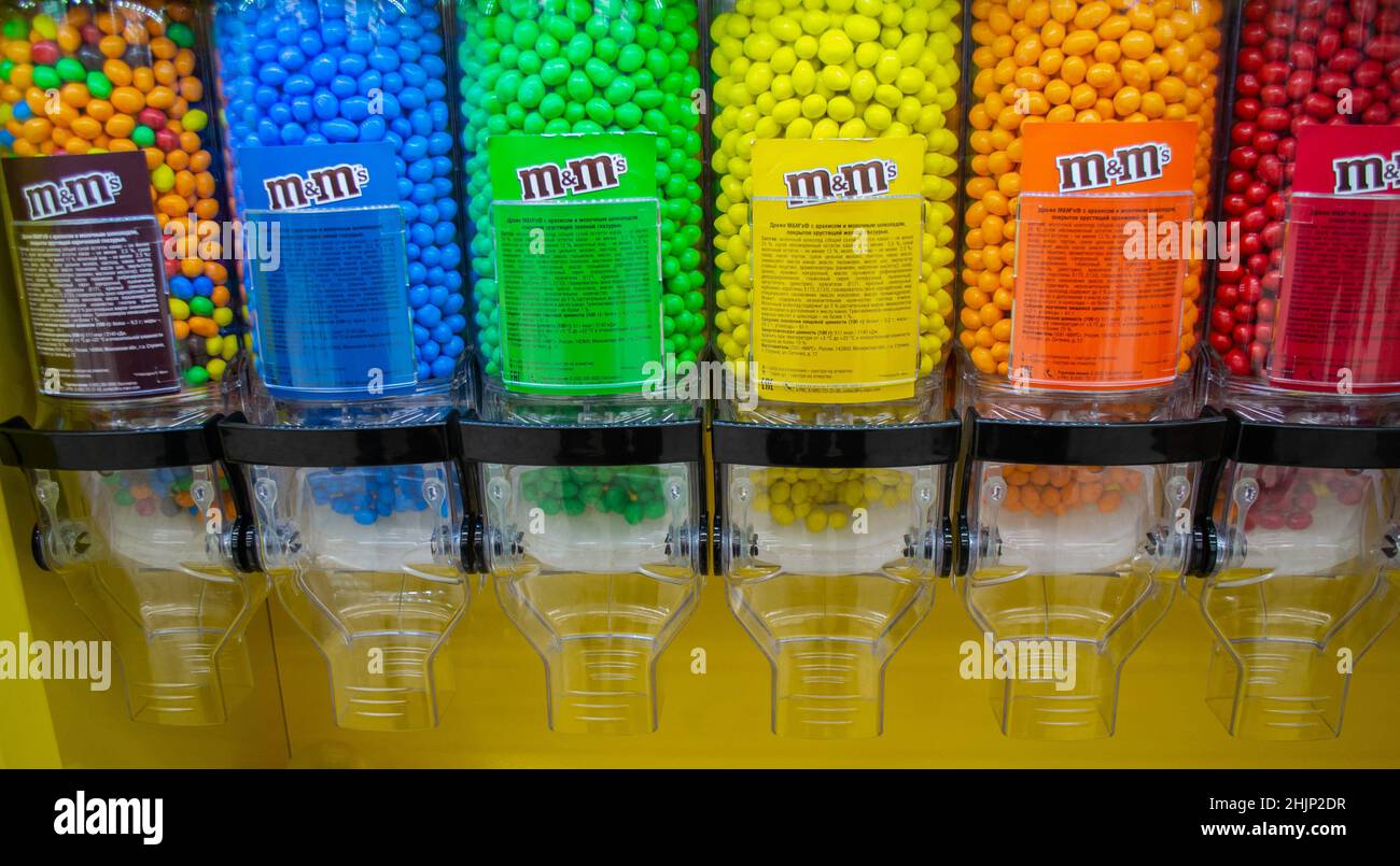Moscow, Russia, November 2019: M M Candies at Candy Dispenser Machines in the supermarket. Colorful button-shaped chocolates in bulk. Stock Photo