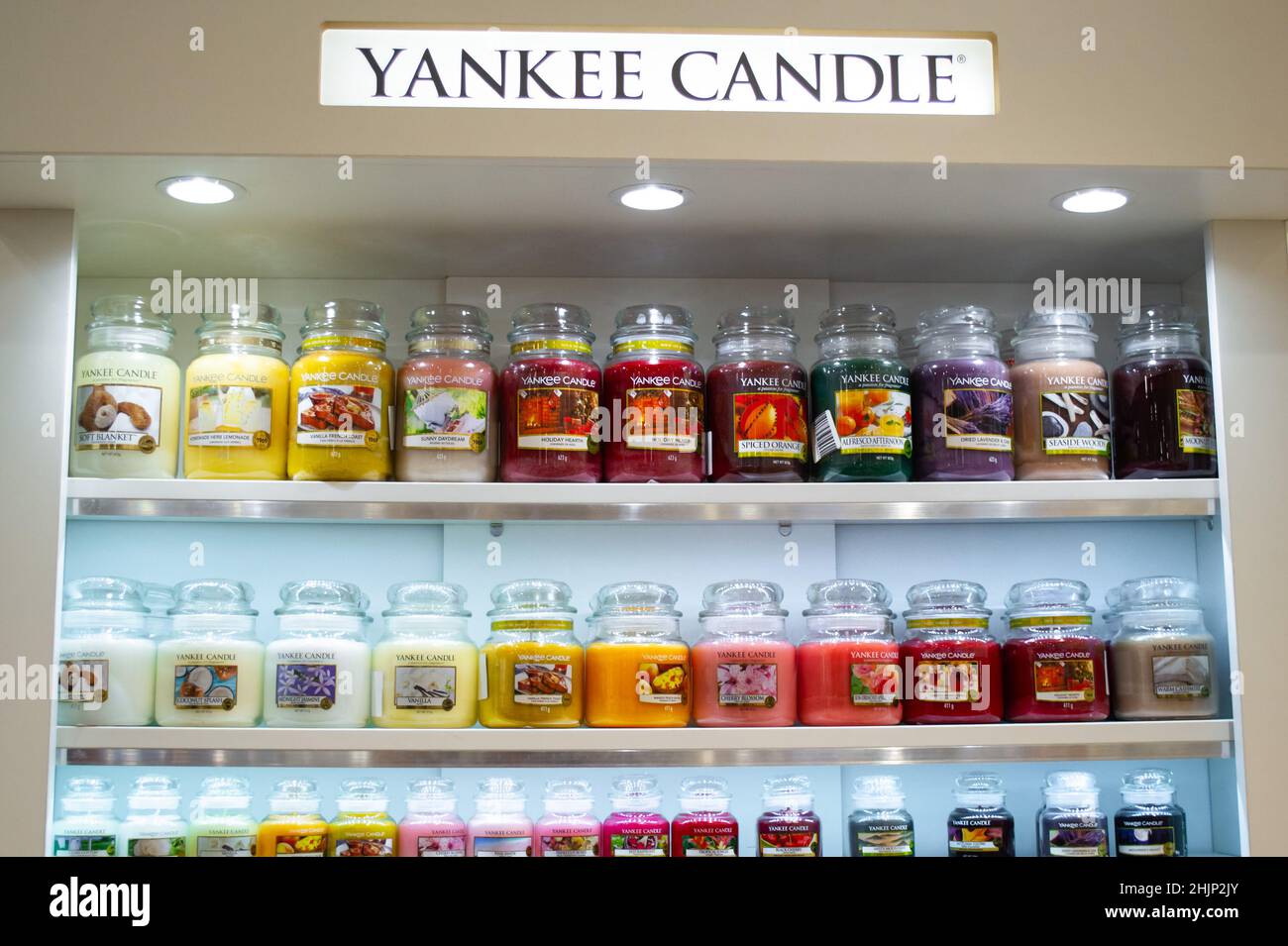 Moscow, Russia, November 2020: Corner of the Yankee candle brand. Showcase with a variety of scented candles in glass jars. Stock Photo