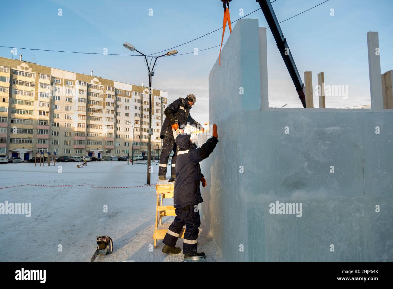 Installers adjust and install another ice block to the overall ...