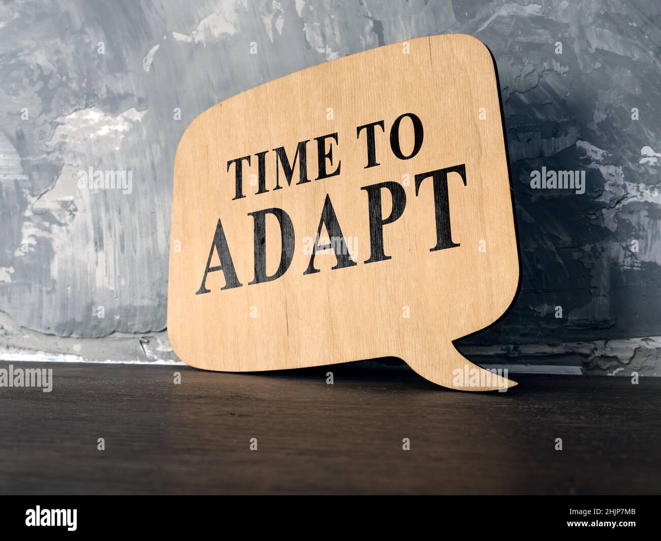 Time to adapt phrase on the wooden desk. Stock Photo