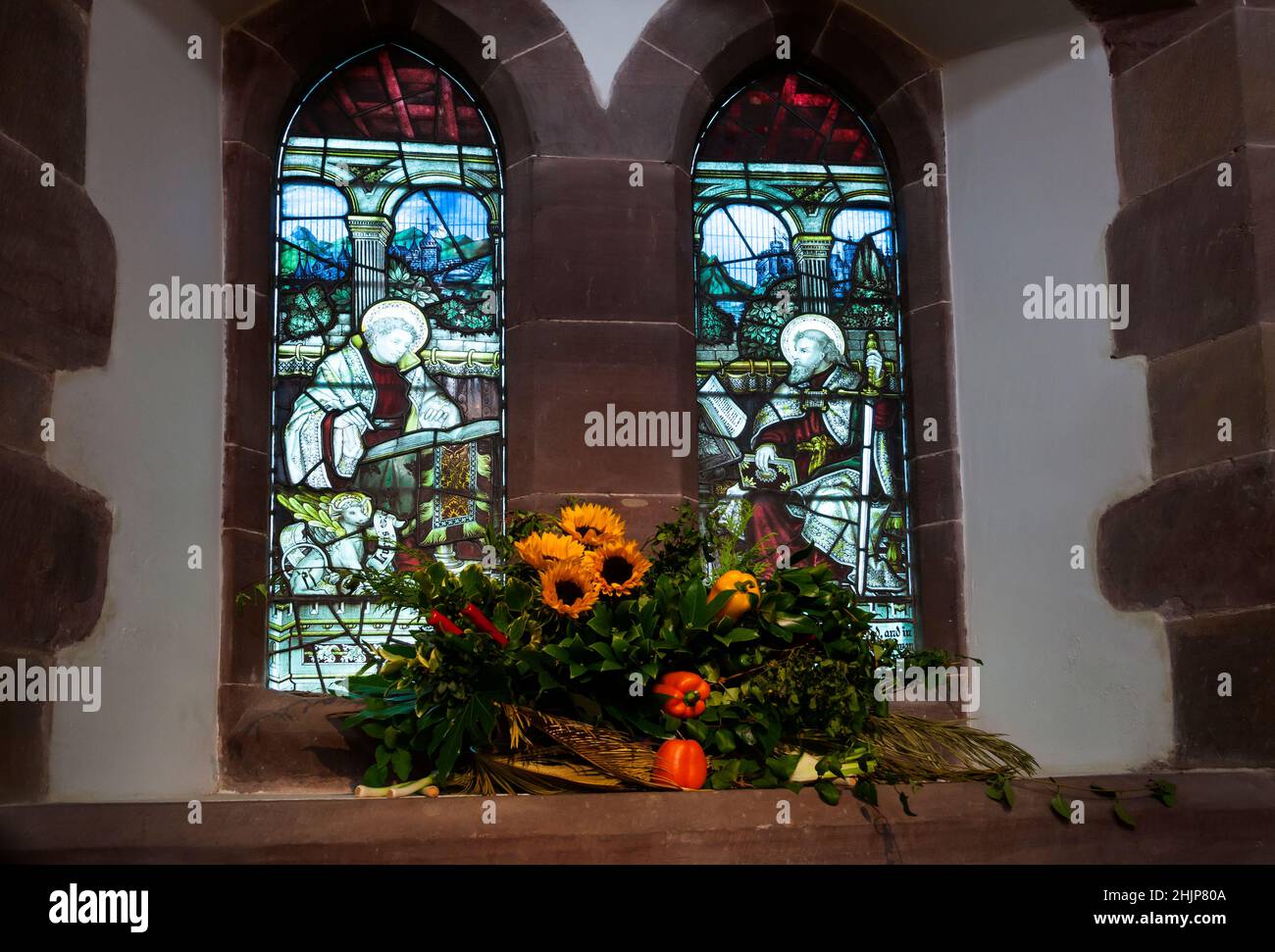 Stained glass window of St Paul and St Luke at St Michael and All Saints Church, Helensburgh, Scotland with arrangement of flowers and fruits. Stock Photo