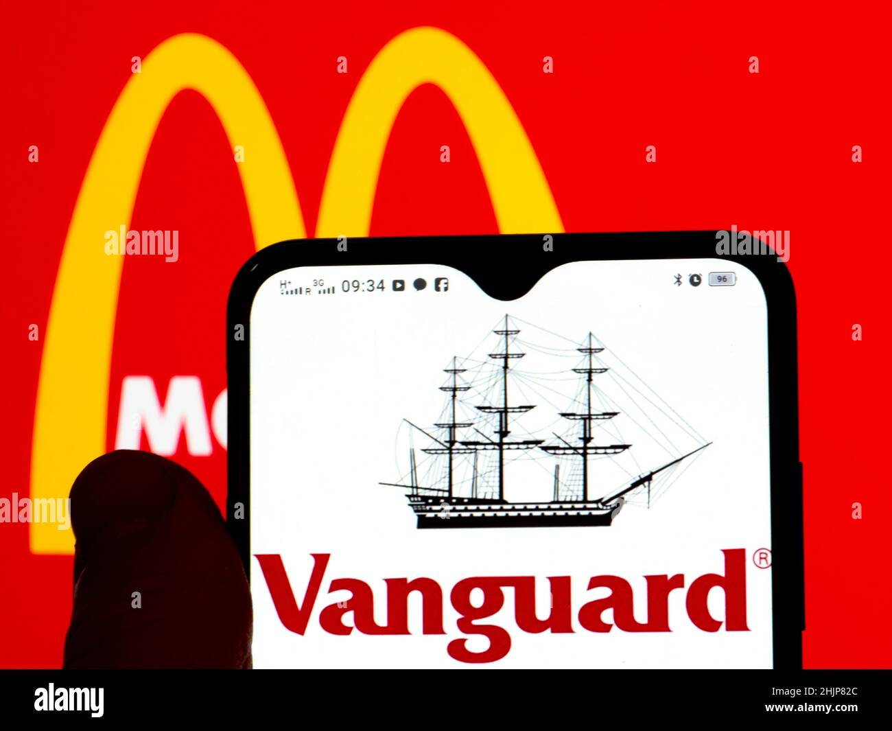 In this photo illustration, the Vanguard Group, Inc. logo is displayed on a smartphone screen with the McDonald's Corporation logo in the background. Stock Photo