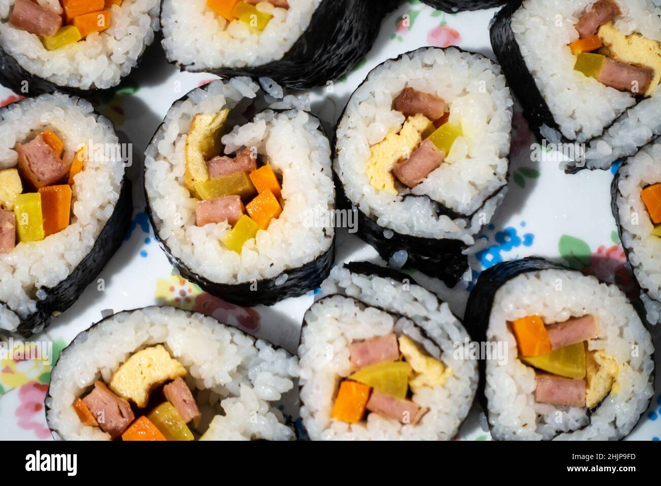 Homemade Korean kimbap or Japanese sushi rolls on a plate seen from above. Stock Photo