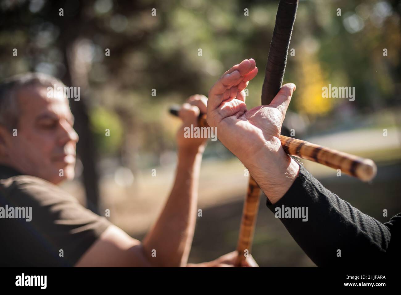 Escrima and kapap instructor demonstrates sticks fighting techniques