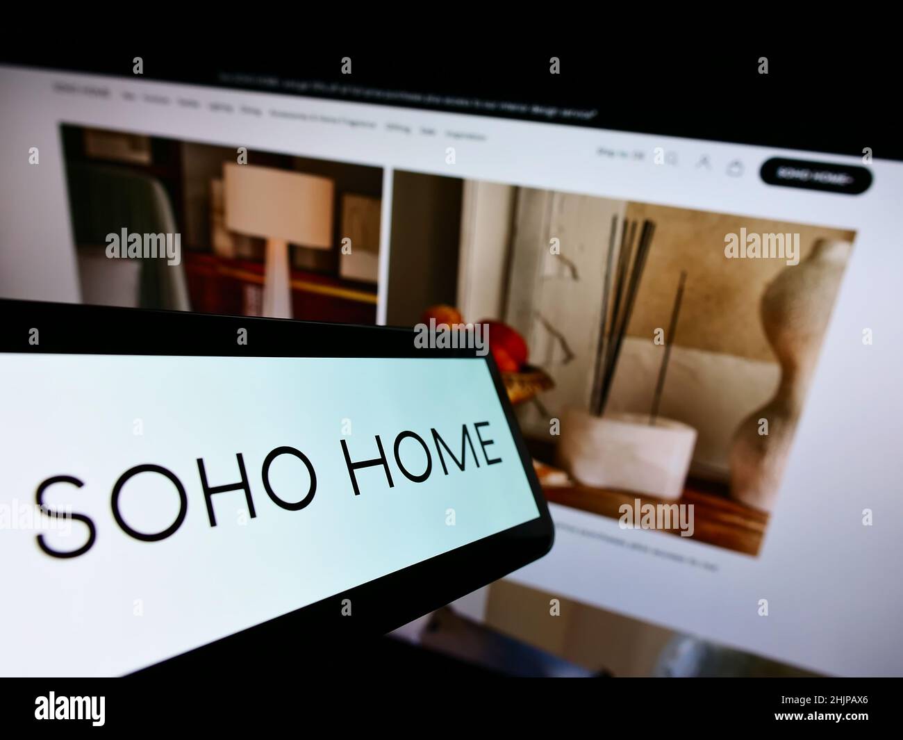 Smartphone with logo of interior design company Soho Home UK 