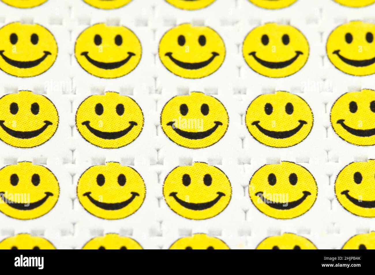 Smiley face acid trips, Blotting paper impregnated with the drug L.S.D.- Lysergic acid diethylamide. Stock Photo