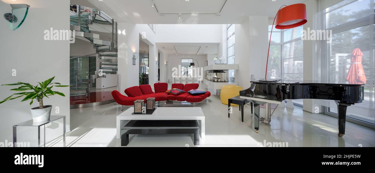 Modern interior of luxury private house. Spacious living room with red ...