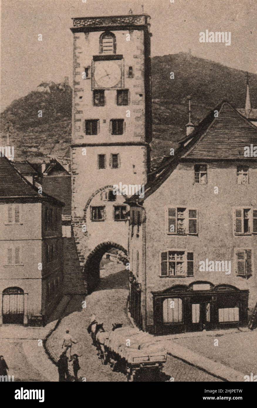 Portrayed in this venerable dwelling-house and gate tower respectively. Alsace-Lorraine (1923) Stock Photo