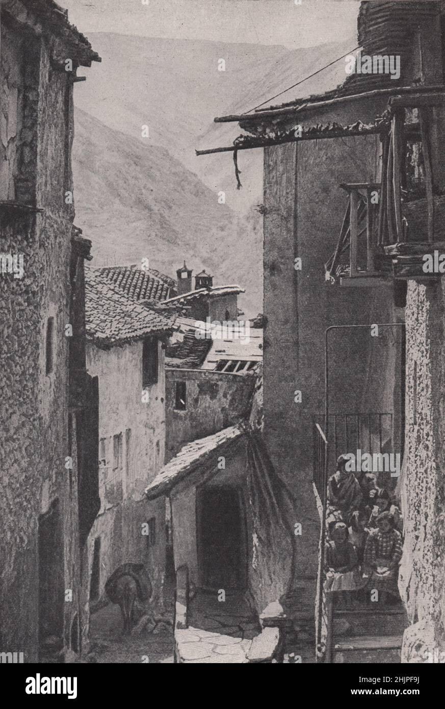 Glimpse of the Sierra Nevada between Time-Worn Walls. Spain. Andalusia (1923) Stock Photo