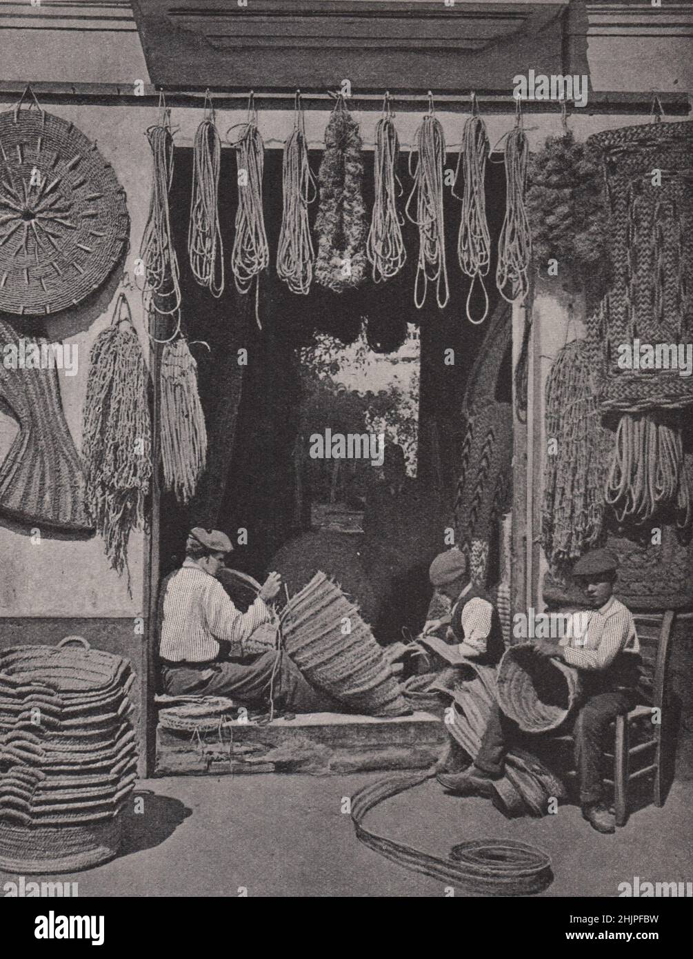 Workmen of Seville making baskets of esparto grass. Spain. Andalusia (1923) Stock Photo