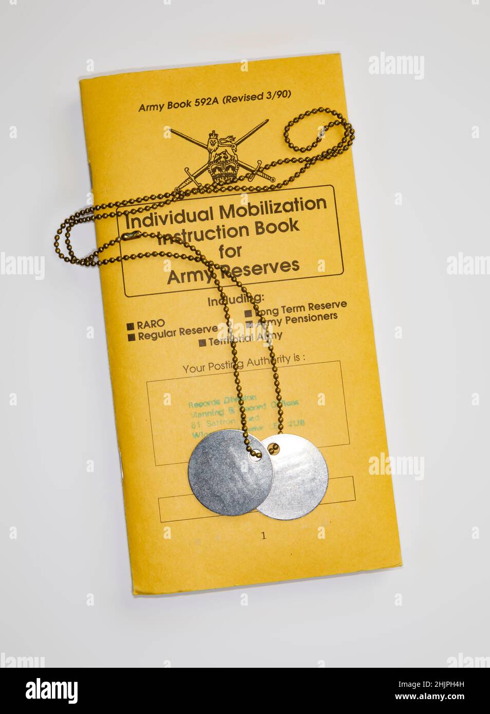 1990's Cold war Individual Mobilization Instruction Book for Army Reserves. To be used in the event of a call up to war. With dog tags, identity discs Stock Photo