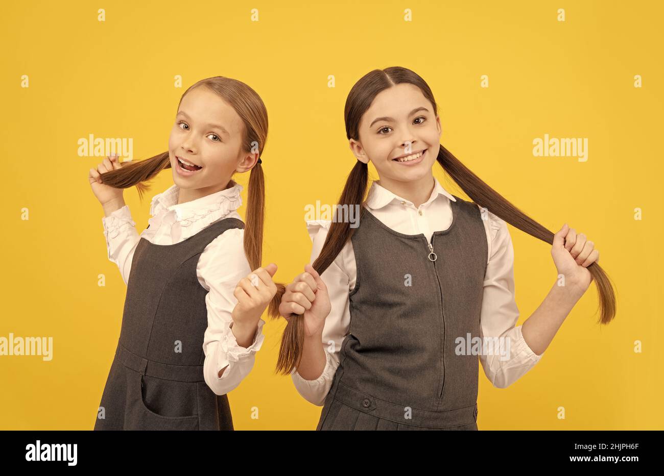For creative learning. Happy children hold long hair. Beauty school