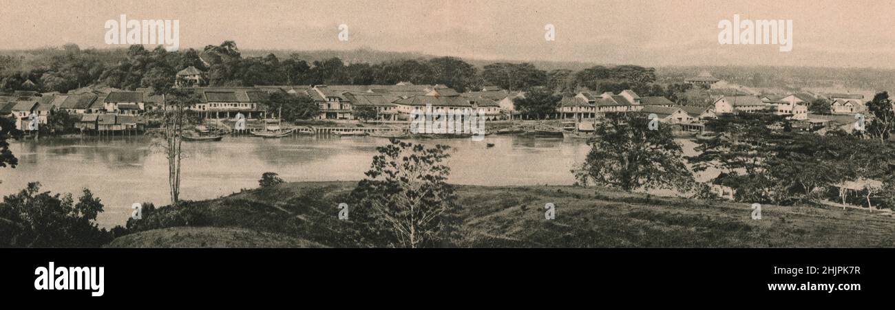 Kuching, capital of Sarawak. The European part occupying the left bank. Barracks, courthouse & the Raja's palace. Malaysia. Borneo (1923) Stock Photo