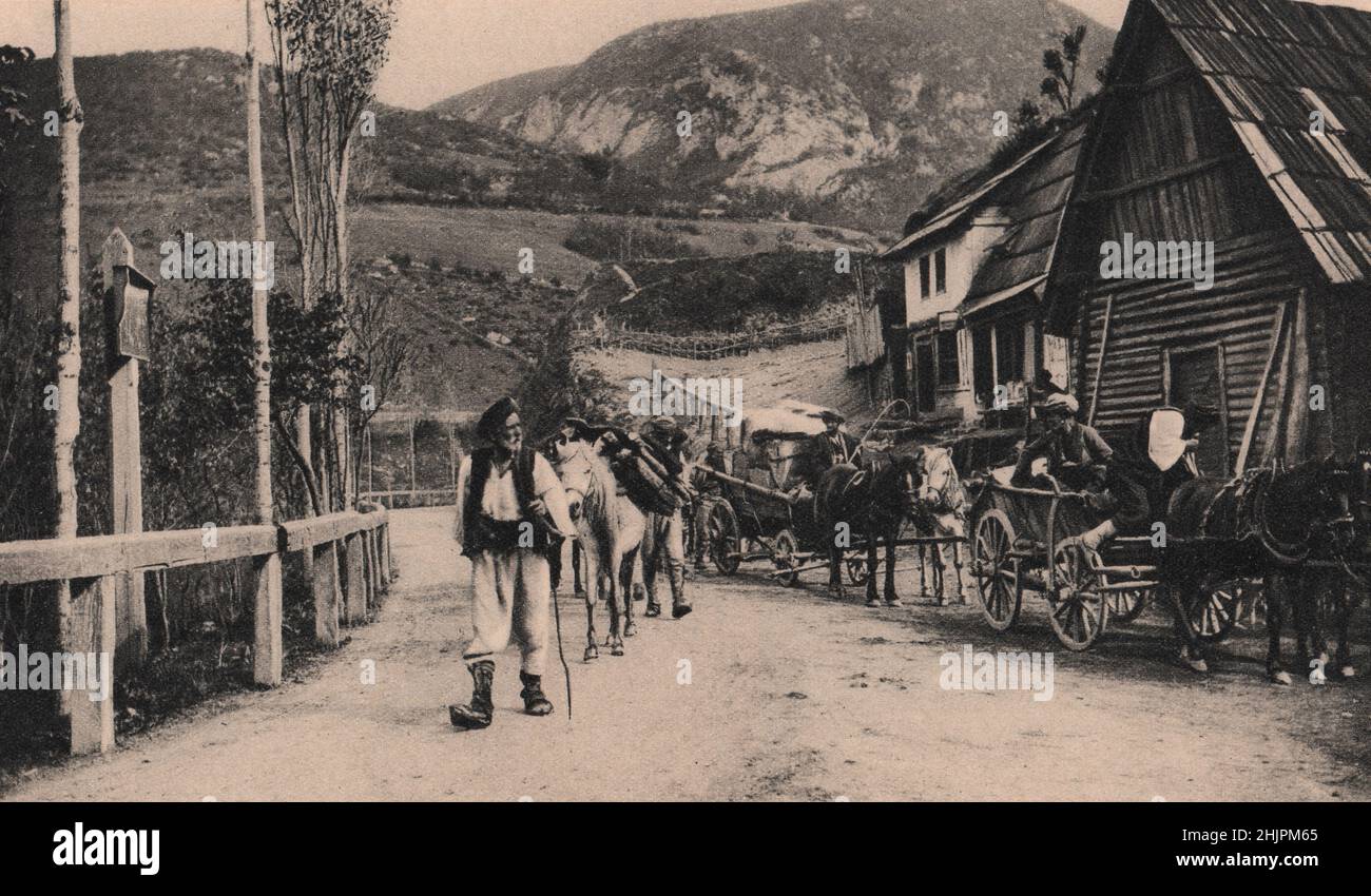 Ark-like wooden houses with roofs blackened by smoke are common even in towns as big as Jajce. Many of them serve as cafés. Bosnia Herzegovina (1923) Stock Photo