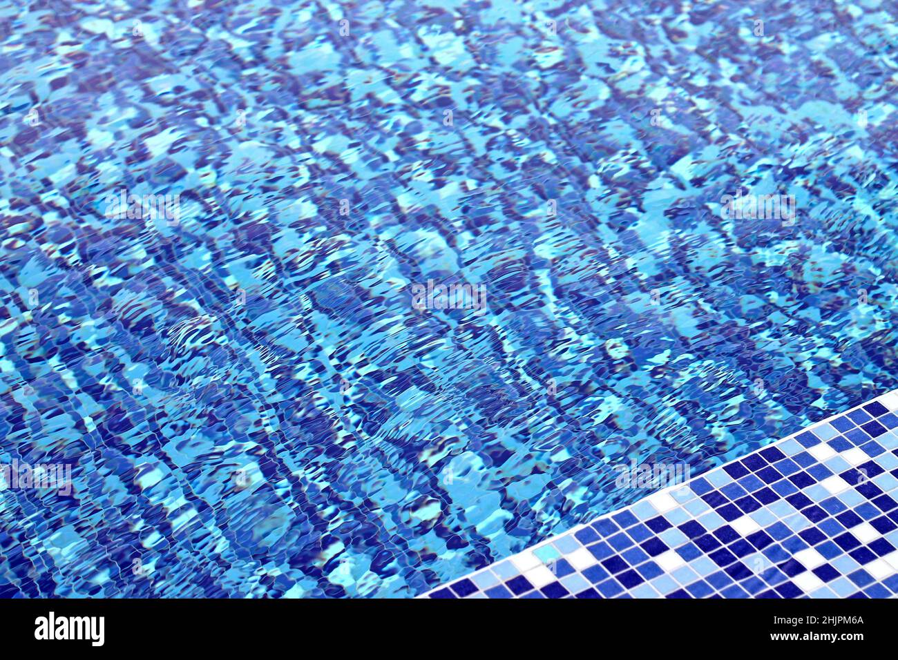 Swimming pool water background. Rippled water in swimming pool. Stock Photo