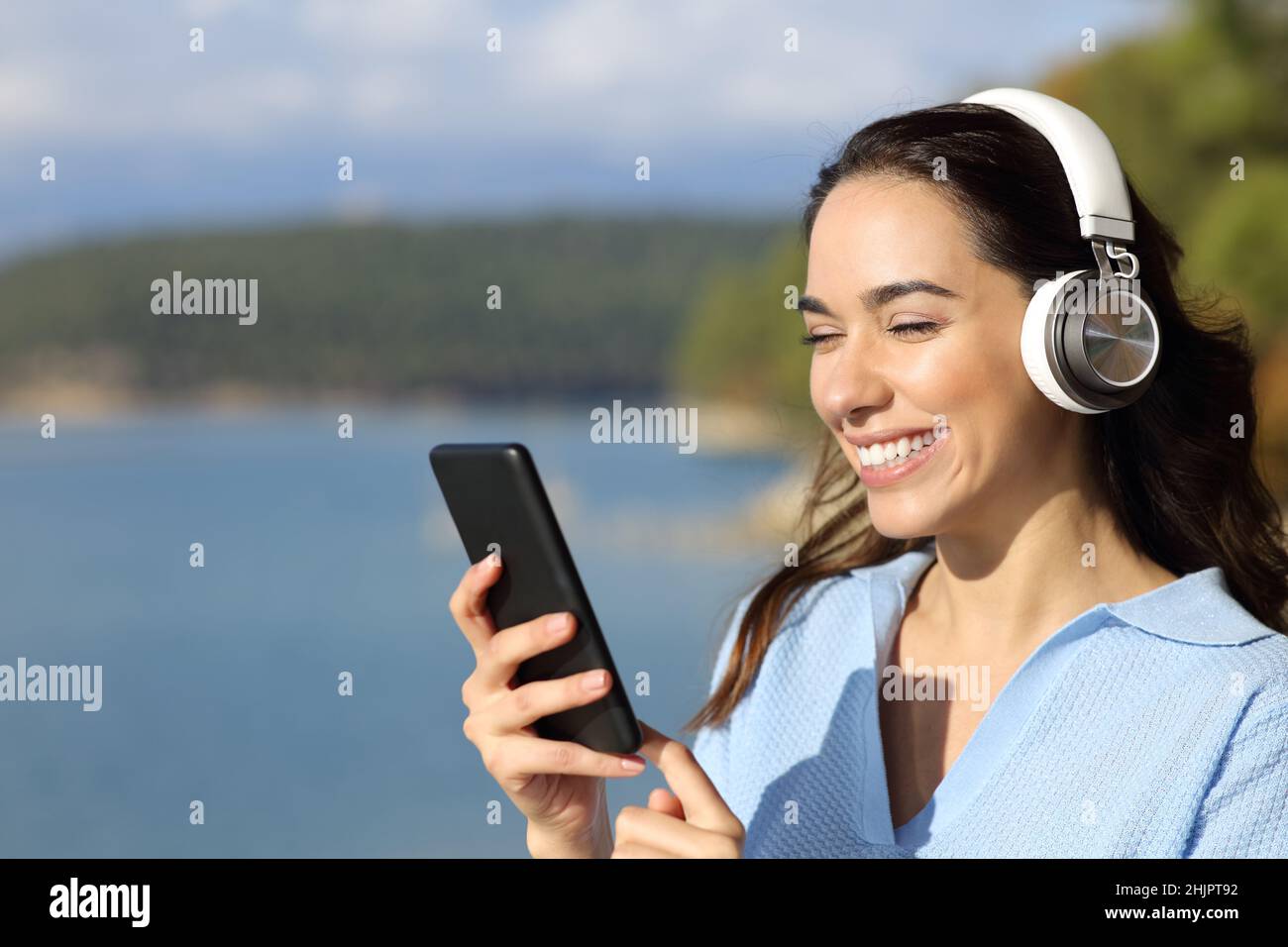 Young woman reading wearing earphones hi res stock photography and