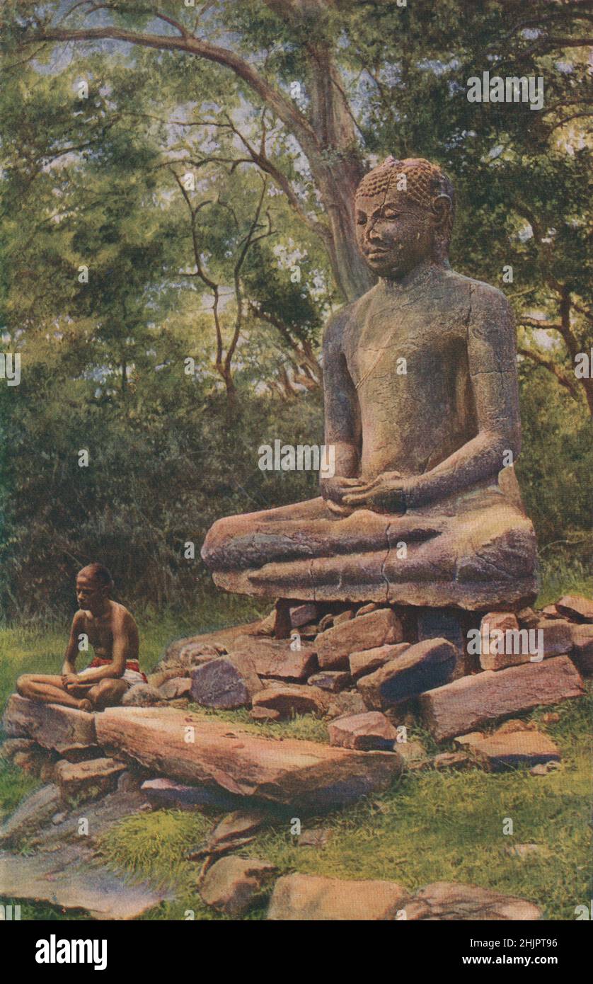 Seated as if wrapped in meditation this colossal stone figure of Buddha is a relic of the past glory of Anuradhapura. Sri Lanka. Ceylon (1923) Stock Photo