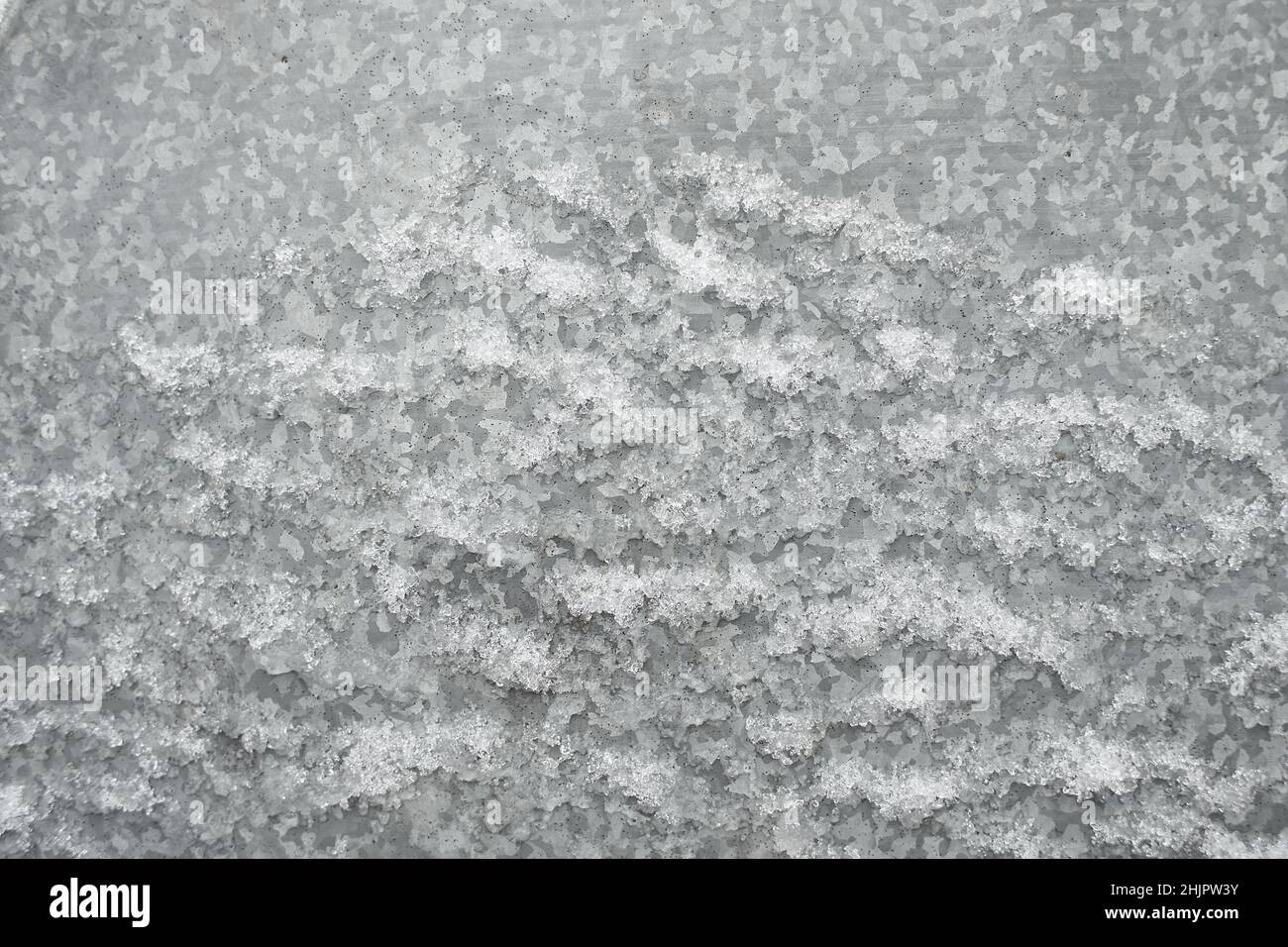 Zinc galvanized sheet of metal covered with ice snow. Can be used as background or texture Stock Photo
