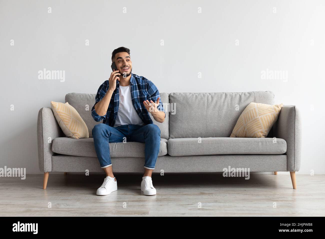 Arab man sitting on couch hi-res stock photography and images - Alamy