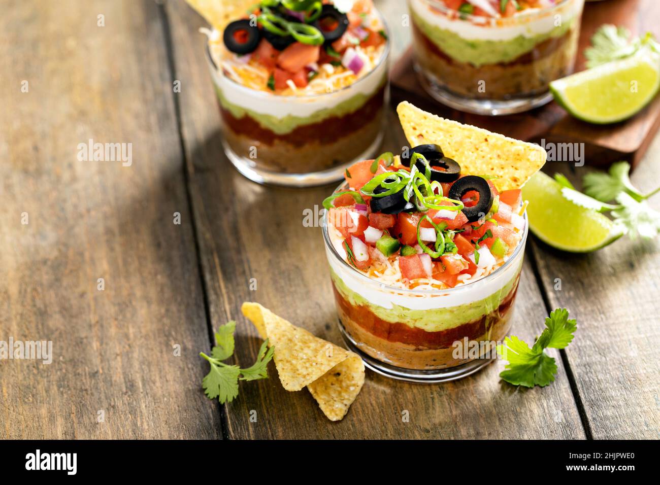 Seven layer dip in individual cups, mexican appetizer Stock Photo Alamy